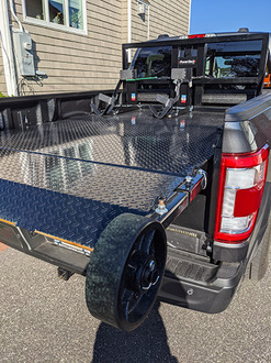 A Truck Featuring A Bed Equipped With A Single Wheel